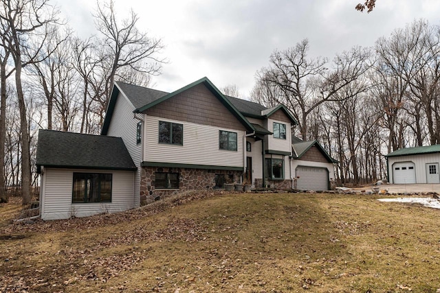 view of front of home featuring a garage, stone siding, and a shingled roof