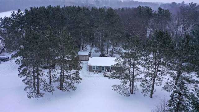 snowy aerial view with a forest view