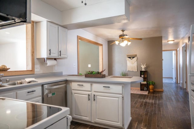 kitchen with light countertops, white cabinets, a peninsula, and stainless steel dishwasher