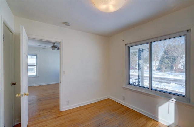 spare room with light wood-style floors and baseboards