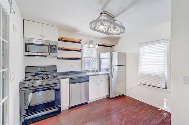 kitchen with stainless steel appliances, a wealth of natural light, open shelves, and white cabinetry