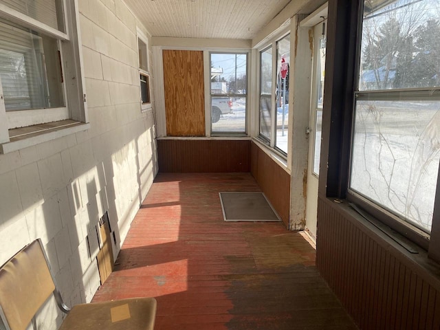 unfurnished sunroom with wooden ceiling and radiator heating unit