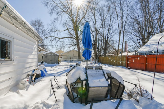 yard layered in snow featuring a fenced backyard