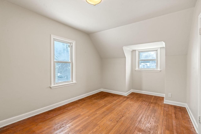 bonus room featuring lofted ceiling, wood finished floors, and baseboards