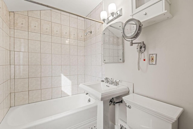 bathroom featuring washtub / shower combination and toilet