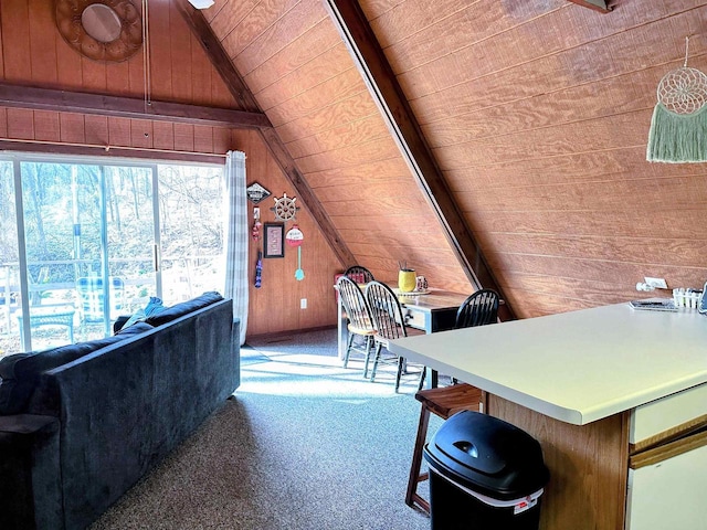 office area featuring lofted ceiling, wood ceiling, wooden walls, and light colored carpet