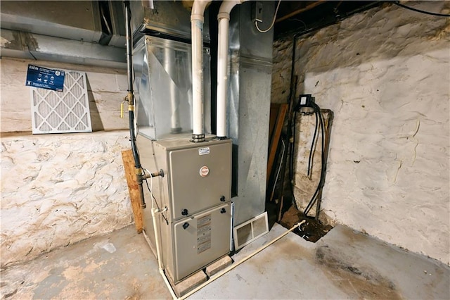 utility room featuring heating unit