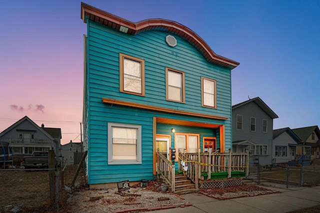 view of front of house with a porch and fence