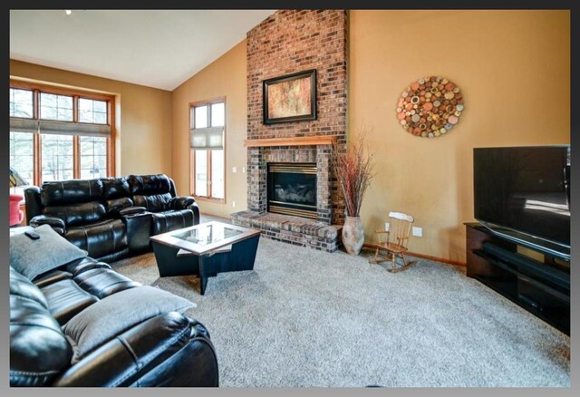 carpeted living area with baseboards, high vaulted ceiling, and a fireplace