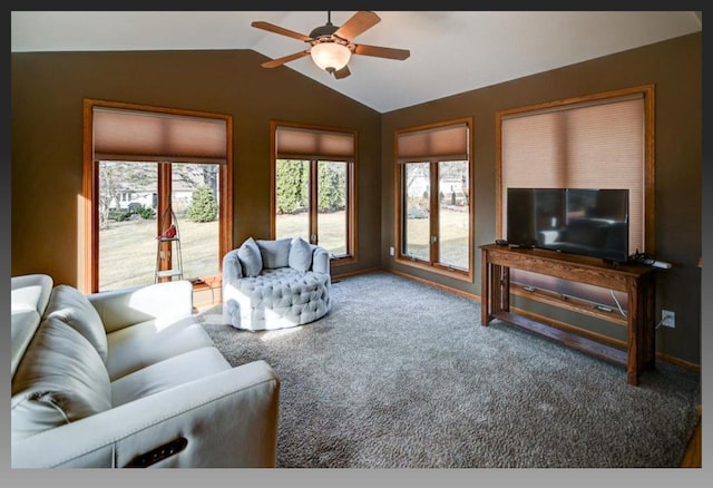 carpeted living area featuring a wealth of natural light, baseboards, a ceiling fan, and lofted ceiling