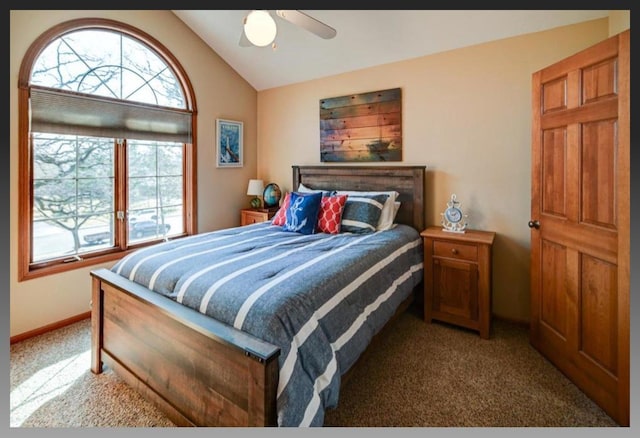 bedroom with baseboards, carpet floors, ceiling fan, and vaulted ceiling