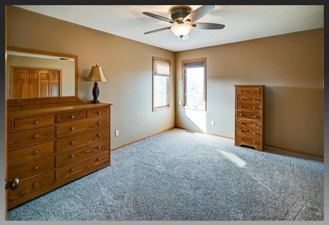 carpeted bedroom featuring baseboards and ceiling fan