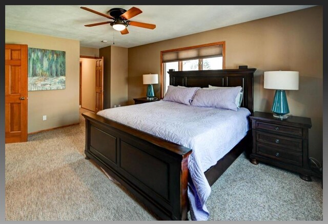 bedroom featuring light colored carpet, baseboards, and ceiling fan