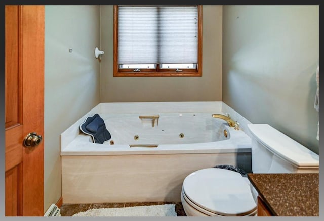 full bath with vanity, toilet, and a whirlpool tub