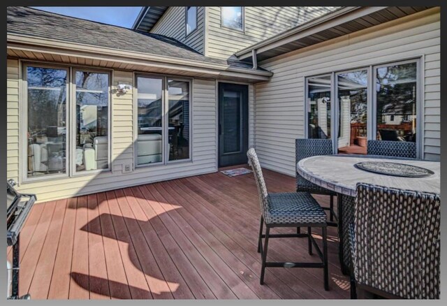 wooden deck with outdoor dining area