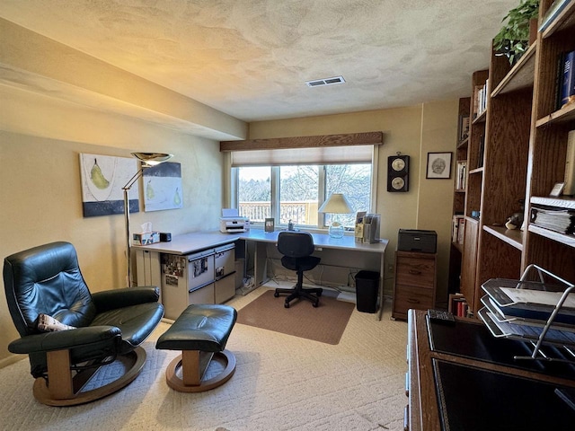 office area featuring visible vents and a textured ceiling