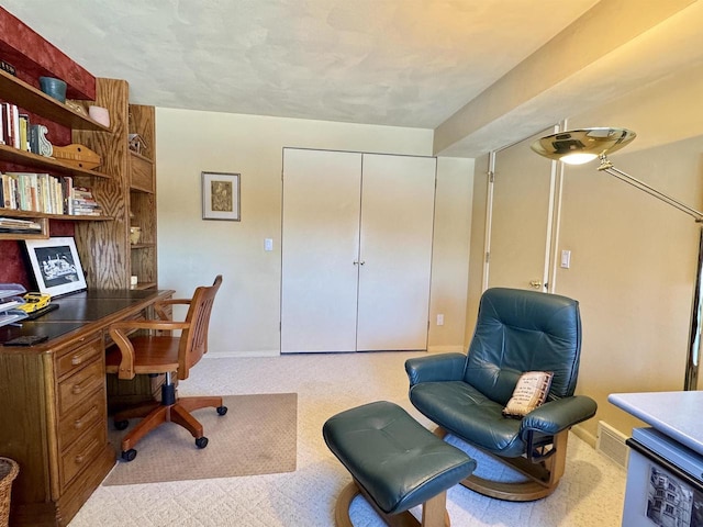 office space with baseboards and light colored carpet