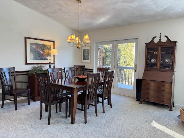 dining area featuring light carpet, baseboards, vaulted ceiling, and a notable chandelier