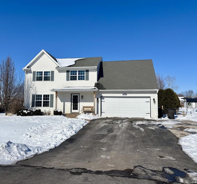 traditional-style home with aphalt driveway and an attached garage