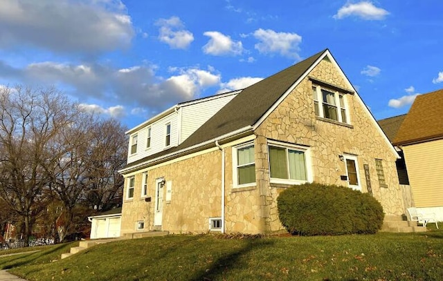 view of side of property with stone siding and a yard