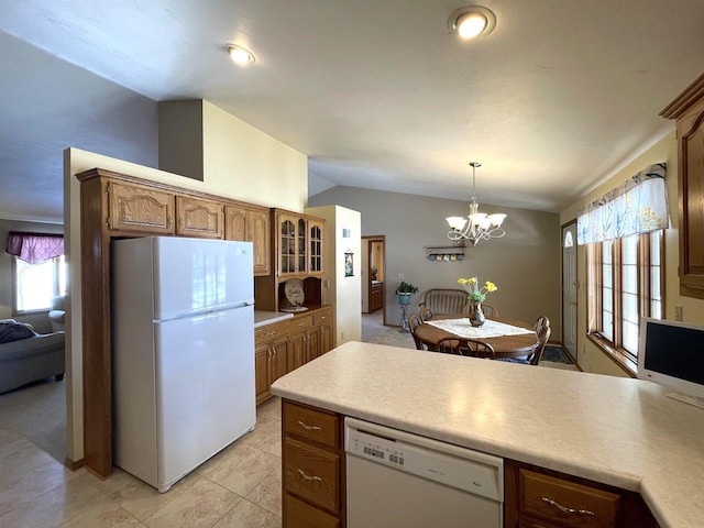 kitchen with light countertops, white appliances, hanging light fixtures, and glass insert cabinets