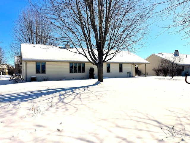 view of snow covered rear of property