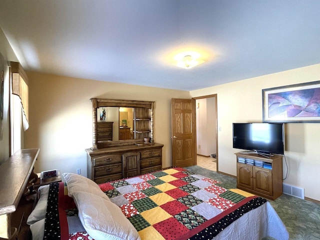 bedroom with baseboards, visible vents, and light colored carpet