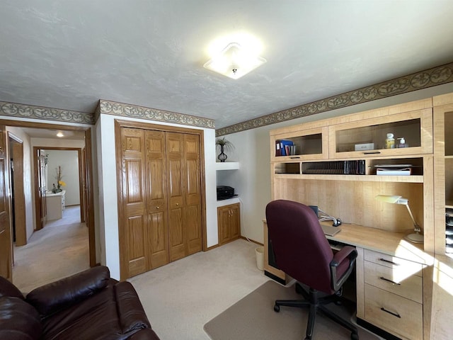 office space with light carpet and a textured ceiling