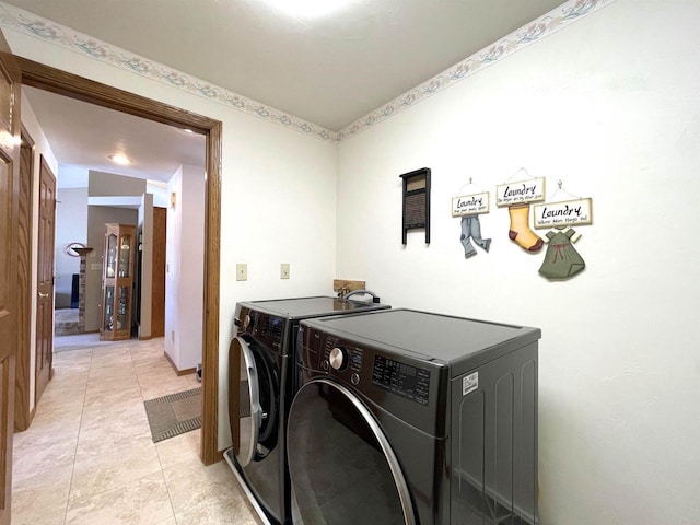 laundry room featuring washer and dryer, laundry area, and light tile patterned floors