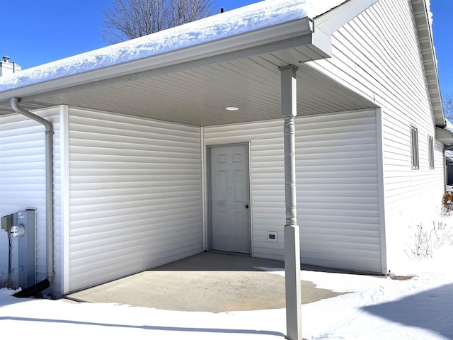 view of snow covered property entrance