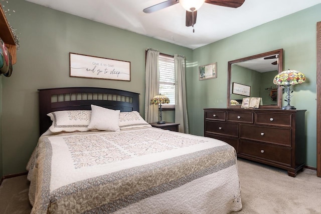 bedroom featuring ceiling fan, baseboards, and light colored carpet