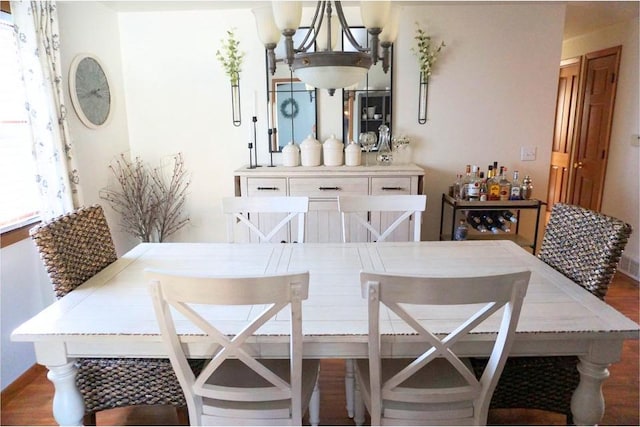 dining space featuring a chandelier and dark wood finished floors