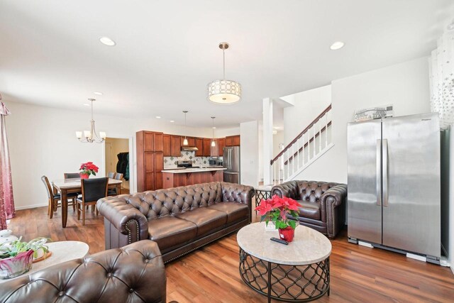 2418 Leopold Way, Sun Prairie, WI 53590 - living room with an inviting chandelier, stairs, wood finished floors, and recessed lighting