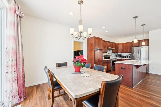 2418 Leopold Way, Sun Prairie, WI 53590 - dining space with baseboards, dark wood finished floors, and a notable chandelier