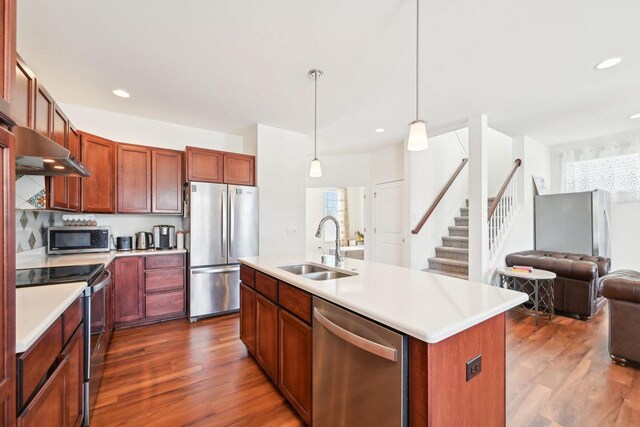 2418 Leopold Way, Sun Prairie, WI 53590 - kitchen featuring stainless steel appliances, light countertops, a sink, and a center island with sink