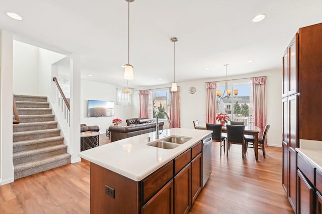 2418 Leopold Way, Sun Prairie, WI 53590 - kitchen featuring a sink, light countertops, hanging light fixtures, dishwasher, and a center island with sink