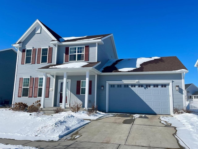 traditional-style home featuring an attached garage and driveway