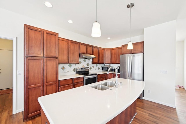 2418 Leopold Way, Sun Prairie, WI 53590 - kitchen with an island with sink, decorative light fixtures, stainless steel appliances, light countertops, and a sink
