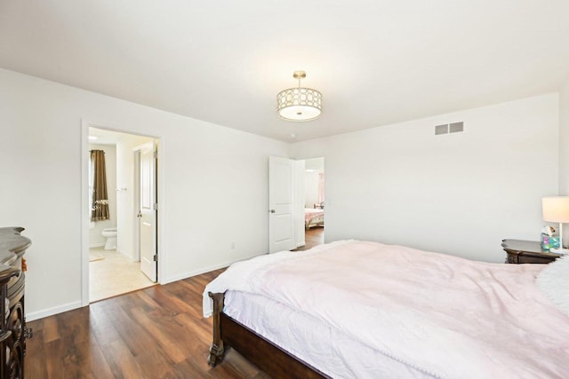 2418 Leopold Way, Sun Prairie, WI 53590 - bedroom featuring dark wood-style floors, ensuite bathroom, visible vents, and baseboards