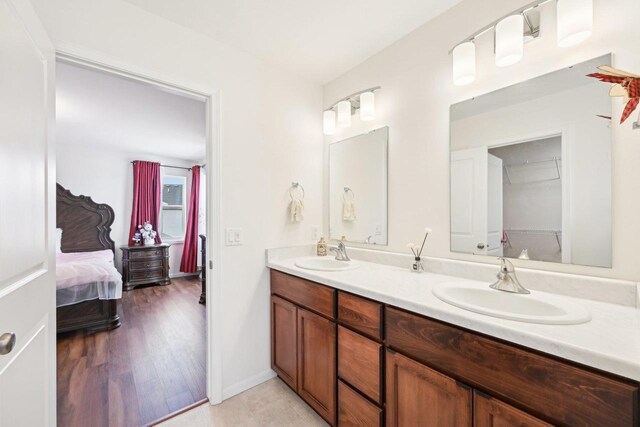 2418 Leopold Way, Sun Prairie, WI 53590 - ensuite bathroom with wood finished floors, connected bathroom, a sink, and double vanity