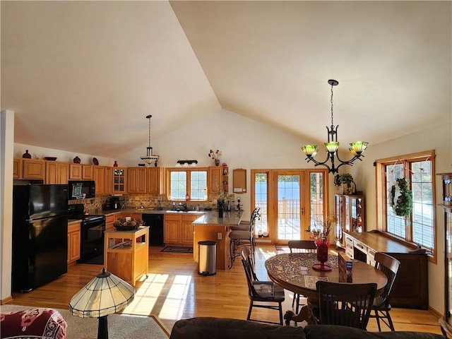 600 S Hayden St, Merrillan, WI 54754 - dining space featuring light wood finished floors, high vaulted ceiling, and a notable chandelier