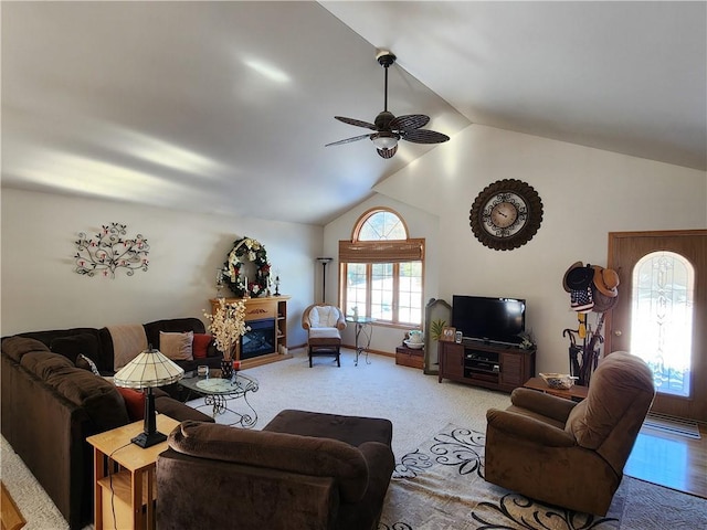 600 S Hayden St, Merrillan, WI 54754 - living area with baseboards, a ceiling fan, vaulted ceiling, carpet flooring, and a fireplace