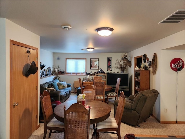 600 S Hayden St, Merrillan, WI 54754 - dining space with visible vents, light carpet, and baseboards