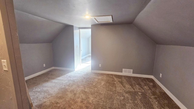 additional living space featuring lofted ceiling, carpet, visible vents, and baseboards