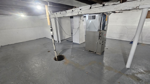 unfinished basement featuring visible vents and heating unit