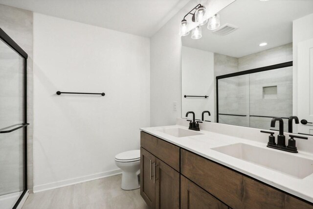 N174W20582 Laurel Springs Cir, Jackson, WI 53037 - bathroom with a stall shower, visible vents, a sink, and toilet