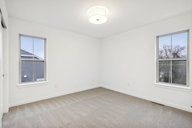 N174W20582 Laurel Springs Cir, Jackson, WI 53037 - spare room featuring baseboards, visible vents, and light colored carpet