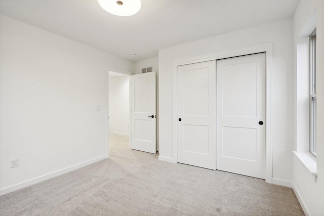 N174W20582 Laurel Springs Cir, Jackson, WI 53037 - unfurnished bedroom with a closet, visible vents, light carpet, and baseboards