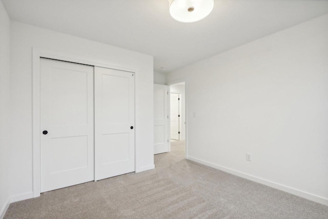N174W20582 Laurel Springs Cir, Jackson, WI 53037 - unfurnished bedroom with light carpet, baseboards, and a closet