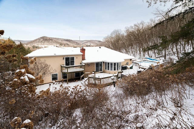 4191 Aspen Ln, La Crescent, MN 55947 - snow covered house featuring a deck with mountain view and a chimney